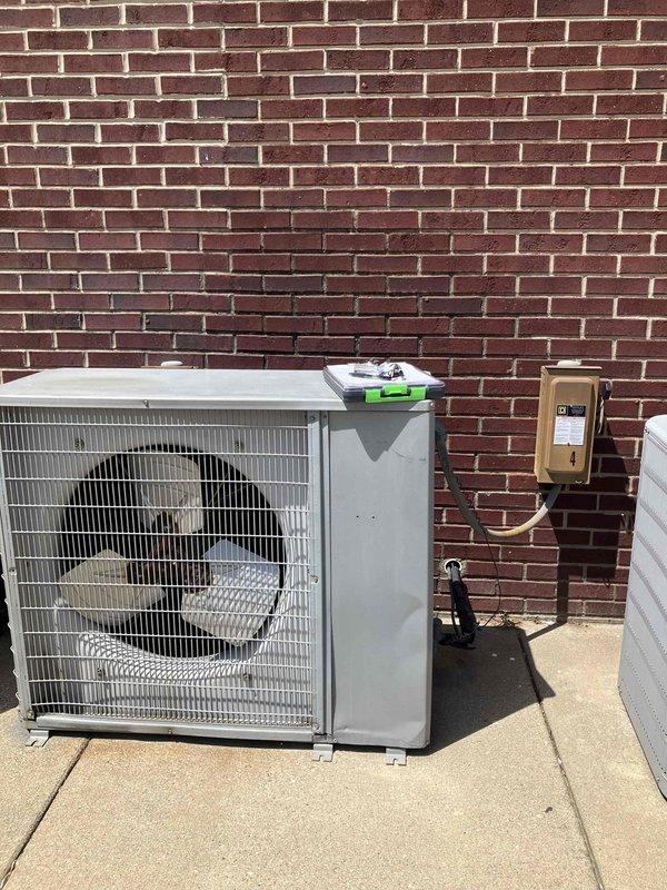 Conducted on-site assessment of two non-operational HVAC systems located at front of building. Evaluated existing equipment including aged furnace unit in basement/utility area with deteriorated ductwork showing significant dust accumulation and surface wear, as well as outdoor condensing unit positioned on concrete pad against exterior brick wall. Documented current system configuration including vertical sheet metal ductwork, PVC condensate piping, electrical disconnect, and cabinet-style furnace with filter access points. Photographed equipment conditions and installation details to develop comprehensive replacement options for complete AC and furnace system upgrades. Provided customer with technical specifications and equipment recommendations for dual system replacement to restore climate control functionality.