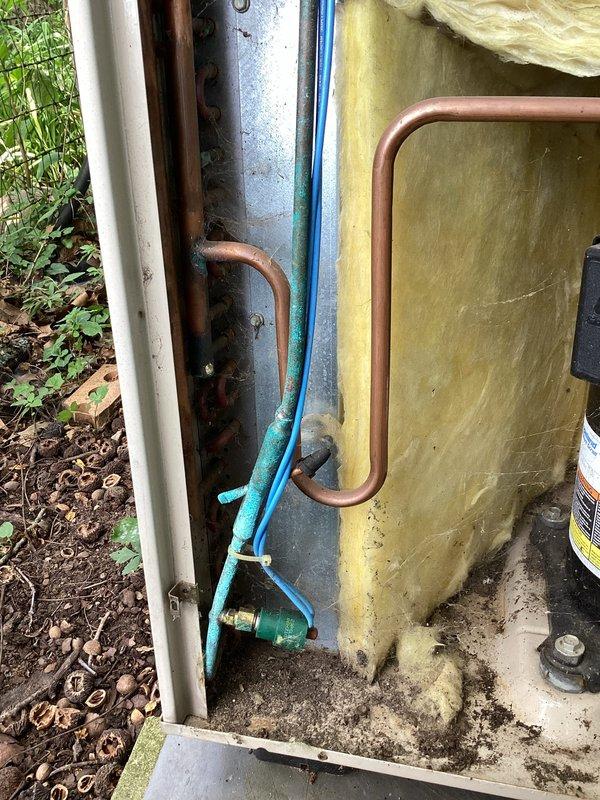 # HVAC Service Report

Responded to no cooling complaint on 29-year-old residential air conditioning system. Upon arrival, performed visual inspection of outdoor condensing unit, which showed significant age-related deterioration including weathered cabinet, oxidized refrigerant lines, and corroded frame components. Unit was positioned on concrete pad with evidence of long-term environmental exposure and minimal recent maintenance.

Given the system's age of 29 years—well beyond the typical 15-20 year service life of residential AC equipment—and the extent of visible wear, advised customer that system has reached end of useful life. Documented equipment condition with photographs showing deteriorated insulation, corroded copper lines, and overall weathering. Recommended full system replacement rather than repair due to age, declining efficiency, and likelihood of additional component failures. Provided customer with replacement options and efficiency upgrade information for modern equi