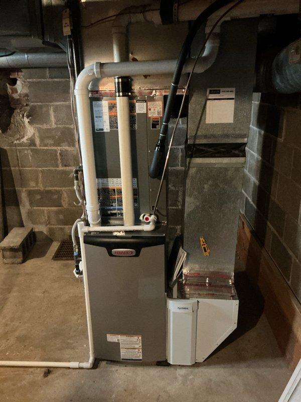 Completed full HVAC system installation including Lennox EL297UH070 furnace, ML17KC1-048 air handler, CK40CT-48C evaporator coil, and Aprilaire 1610 humidifier with S200 thermostat. Installed all equipment in basement mechanical room with proper PVC venting routed through ceiling, verified all electrical connections and gas piping, completed startup procedures per manufacturer specifications, and confirmed system operation. Unit tested and left operational with customer instructed on thermostat functions.