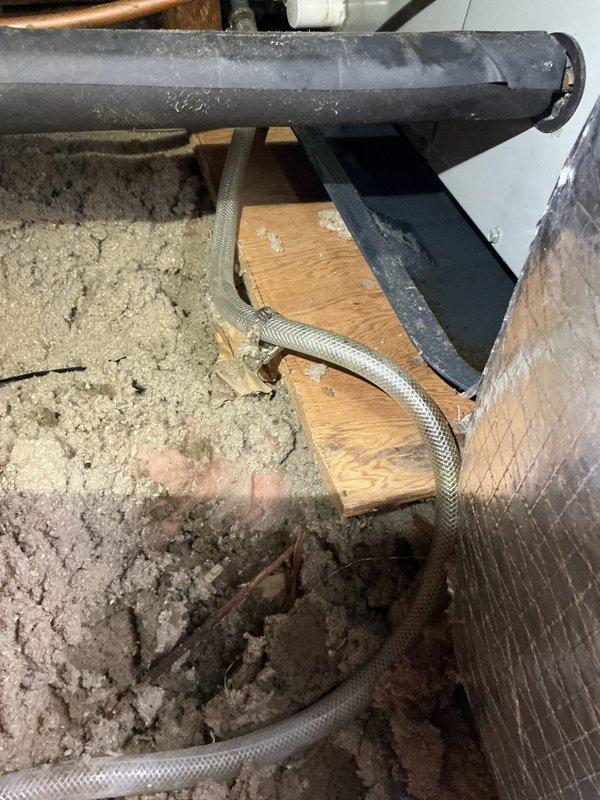 # HVAC Service Report

Responded to emergency no-cool call for residential air conditioning system less than ten years old that failed following recent repair. Upon arrival, accessed attic-mounted equipment to diagnose system malfunction. 

Conducted thorough inspection of HVAC components including condensate drain system, refrigerant lines, and associated mechanical connections. Identified issues with condensate management system, including PVC drain line showing moisture accumulation and potential drainage concerns. Examined copper refrigerant lines and braided flex connections for proper installation and secure mounting. 

Verified all pipe supports, brackets, and mounting hardware were properly secured to structural members. Assessed insulation coverage and equipment accessibility for proper system operation. Documented existing conditions of water heater proximity to HVAC equipment and verified adequate clearances per code requirements.

Performed system diagnostics to determine r