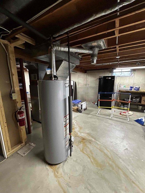 Provided quote for removal of existing chimney box and installation of new flashing, collar, and cap to be completed prior to scheduled roof replacement. Documented current conditions of water heater venting system in basement utility area and electrical panel configuration. Work to be coordinated with roofing contractor timeline to ensure proper integration of new chimney components with replacement roof installation.