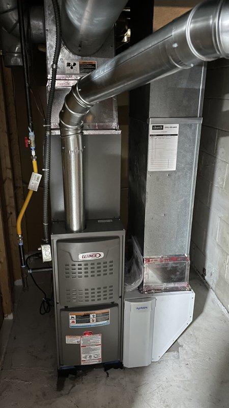 Completed full HVAC system installation including Lennox ML180UH045 furnace, ML13KC1-024 air conditioner, CK40CT-24A evaporator coil, and T4 thermostat in basement utility area. Installed Aprilaire humidifier unit and configured all ductwork connections with galvanized steel supply and return air ducts. Verified gas line connections, performed system startup checklist per manufacturer specifications, confirmed proper line voltage and gas supply pressure, and tested all components for operational functionality.