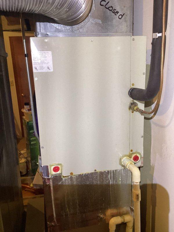 Responded to no cooling complaint on 20-year-old York air conditioning system. Upon arrival, confirmed lack of cooling throughout residence with intermittent outdoor fan operation. Performed diagnostic evaluation of system components including compressor, capacitor, and refrigerant levels. Inspected evaporator coil and air handler for proper airflow and operational status. Noted visible water staining and deterioration on lower section of air handler cabinet indicating previous moisture issues. Checked electrical connections, contactor operation, and thermostat communication. Given the age of the equipment at two decades old, discussed system condition and repair versus replacement options with homeowner. Provided recommendations for addressing cooling failure and outlined available solutions to restore comfort to home.