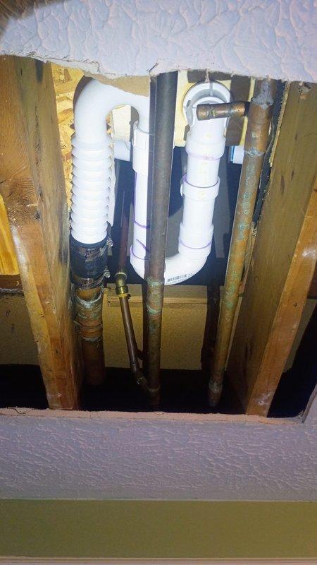 Responded to no hot water complaint on recently installed tankless water heater less than one year old. Upon arrival, accessed crawl space beneath residence to inspect unit and plumbing connections. Identified installation deficiency from prior contractor's work affecting unit operation. Corrected improper installation issue, restored hot water functionality, and verified proper system performance before completing service call.