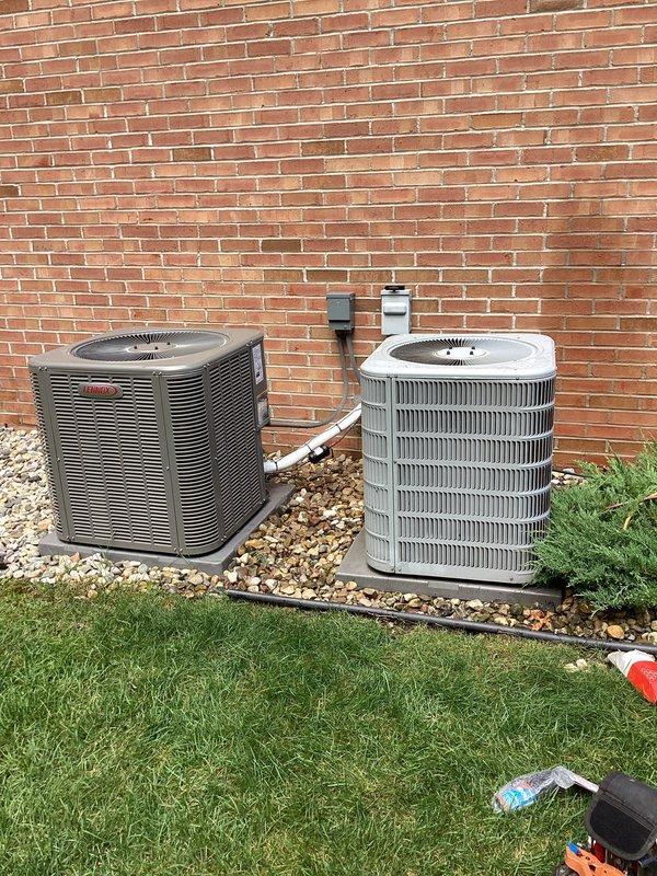 Responded to no cooling complaint for upstairs zone on dual-system residential property with unit less than one year old. Upon arrival, performed diagnostic evaluation of outdoor condensing units positioned on gravel pads against exterior brick wall. Inspected both systems for proper operation, airflow, and refrigerant line connections. Visual inspection revealed debris accumulation on outdoor unit fins, which can restrict airflow and reduce cooling efficiency. Verified system operation, checked electrical connections at exterior disconnect boxes, and assessed overall unit condition. Confirmed airflow at vents and ruled out frozen evaporator coil concerns. Recommended cleaning of condenser coils to restore optimal heat transfer and system performance for inadequate upstairs cooling issue.