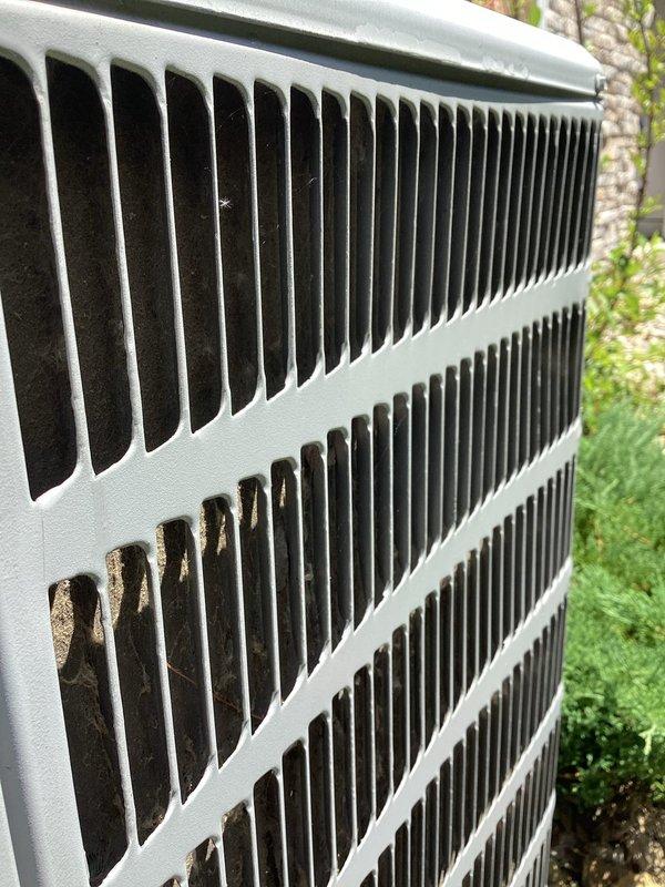 Responded to no cooling complaint for upstairs zone on dual-system residential property with unit less than one year old. Upon arrival, performed diagnostic evaluation of outdoor condensing units positioned on gravel pads against exterior brick wall. Inspected both systems for proper operation, airflow, and refrigerant line connections. Visual inspection revealed debris accumulation on outdoor unit fins, which can restrict airflow and reduce cooling efficiency. Verified system operation, checked electrical connections at exterior disconnect boxes, and assessed overall unit condition. Confirmed airflow at vents and ruled out frozen evaporator coil concerns. Recommended cleaning of condenser coils to restore optimal heat transfer and system performance for inadequate upstairs cooling issue.