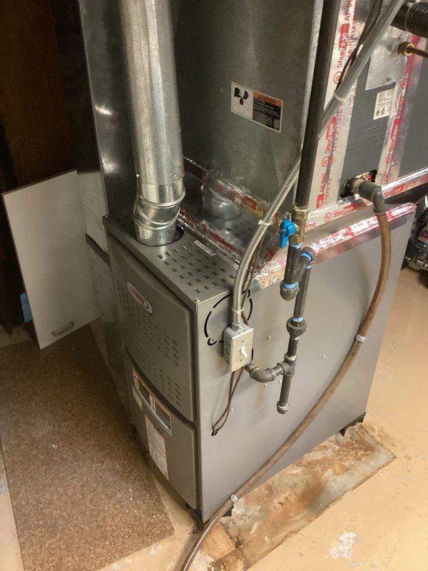 Completed installation of ML180UH090 furnace unit in basement utility area. Reused existing filter rack and thermostat from previous system. Confirmed presence of chimney liner for proper venting. Connected all necessary ductwork, gas lines, and electrical components per manufacturer specifications. System tested and operational upon completion.