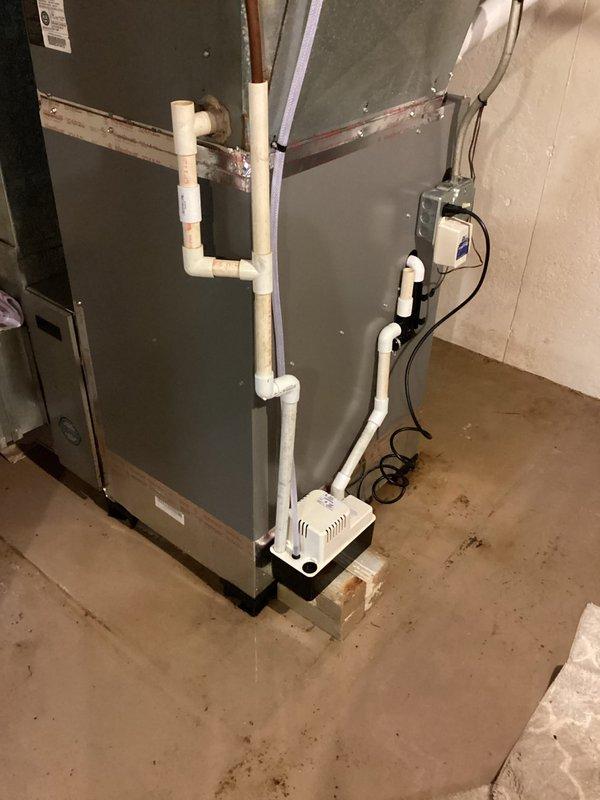 Responded to service call for condensate drainage issue caused by plugged PVC drain line. Installed new condensate pump with vinyl tubing to replace the existing long run of obstructed PVC piping, ensuring proper drainage from the air handler unit. Applied A/C Renew lubricant treatment to the air conditioning system to enhance performance and longevity of system components.