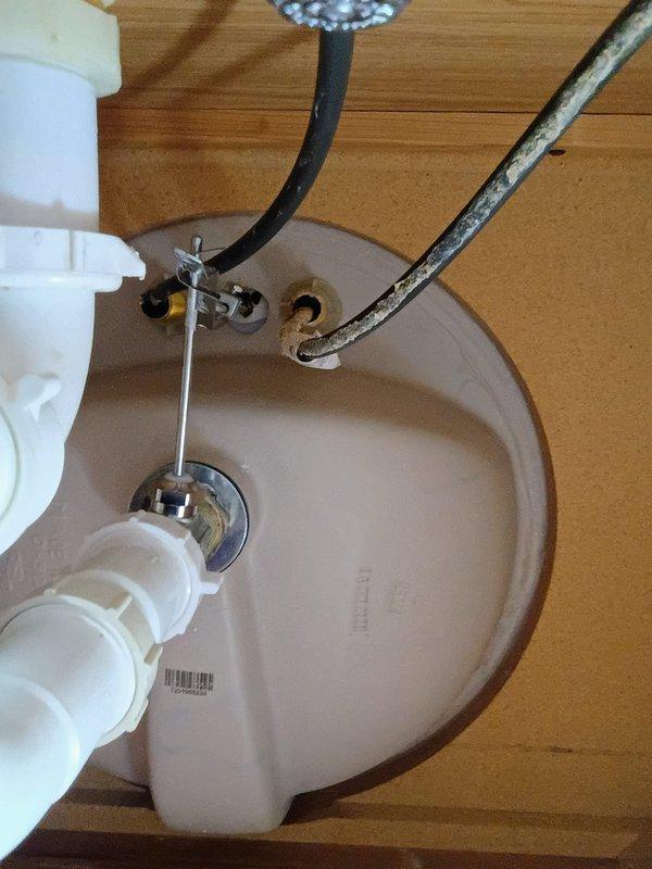 Responded to a water leak under the bathroom sink caused by deteriorated black rubber supply hoses. Removed the old corroded hoses and installed new braided metal supply lines to both hot and cold water connections. Verified all connections were secure, tested for leaks, and confirmed proper water flow to the faucet. The minor drip that had been ongoing for three weeks was successfully eliminated, preventing potential water damage to the vanity cabinet in this 1985-built home.