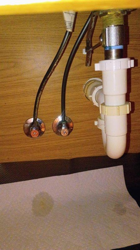 Responded to a water leak under the bathroom sink caused by deteriorated black rubber supply hoses. Removed the old corroded hoses and installed new braided metal supply lines to both hot and cold water connections. Verified all connections were secure, tested for leaks, and confirmed proper water flow to the faucet. The minor drip that had been ongoing for three weeks was successfully eliminated, preventing potential water damage to the vanity cabinet in this 1985-built home.