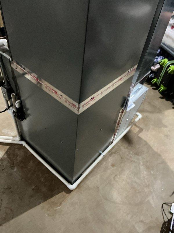 Completed full HVAC system installation including EL297UH090 furnace, EL18KCV-048 air conditioner with 4-ton capacity, CK40CT-36C evaporator coil, 1610 air handler, 600M whole-home humidifier, S200 programmable thermostat, and air scrubber for enhanced indoor air quality. Installed condensate drainage system with PVC piping and clear drain lines, mounted digital control interface on supply ductwork, and performed system balance to ensure optimal airflow and efficiency across all components.