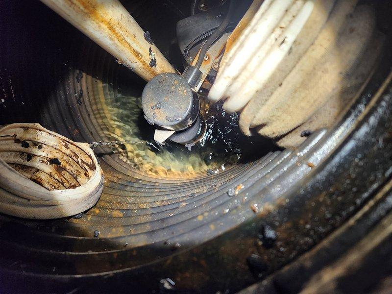 Responded to emergency call for groundwater sump pump running continuously without keeping up with water flow. Upon arrival, conducted diagnostic inspection of pump system and surrounding components. Found significant debris accumulation and moisture throughout pump assembly affecting operational efficiency. Inspected blower wheel assembly which showed extensive dust, dirt, and sediment buildup restricting proper function. Noted corrosion on metal piping and connections, with visible rust deterioration on multiple components. Examined electrical connections and wiring for integrity. Documented condensation and water accumulation on corrugated discharge tubing and surrounding ductwork. Assessed insulated piping showing age-related discoloration and wear. Pump motor verified as operational but struggling due to system restrictions and accumulated debris in housing. Photographed conditions for documentation purposes. Provided recommendations for system cleaning, component replacement, and