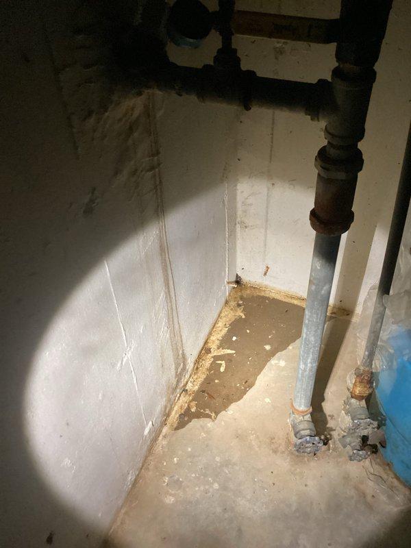 Responded to callback for reported water accumulation under pressure tank and water heater. Upon arrival, conducted thorough inspection of the area and documented conditions with photographs. Examined all visible plumbing connections, pipe fittings, and fixtures in the utility room. Inspected pressure tank connections, water heater installations, and associated piping for active leaks or moisture sources. Observed significant pre-existing water staining on walls and evidence of long-term moisture issues in the space. Checked all recent work performed in the area, including pipe connections and fittings, confirming proper installation and no active leaking from our previous service. Verified all joints, couplings, and connections were secure and dry. Determined that observed moisture and staining appeared consistent with historical water damage rather than new active leaks from recently serviced equipment. Documented findings photographically for record purposes.