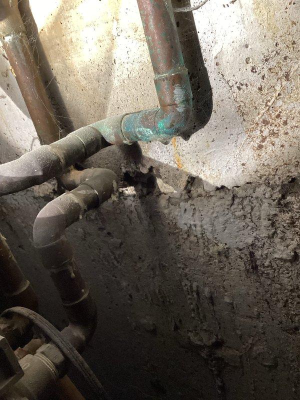 Responded to callback for reported water accumulation under pressure tank and water heater. Upon arrival, conducted thorough inspection of the area and documented conditions with photographs. Examined all visible plumbing connections, pipe fittings, and fixtures in the utility room. Inspected pressure tank connections, water heater installations, and associated piping for active leaks or moisture sources. Observed significant pre-existing water staining on walls and evidence of long-term moisture issues in the space. Checked all recent work performed in the area, including pipe connections and fittings, confirming proper installation and no active leaking from our previous service. Verified all joints, couplings, and connections were secure and dry. Determined that observed moisture and staining appeared consistent with historical water damage rather than new active leaks from recently serviced equipment. Documented findings photographically for record purposes.