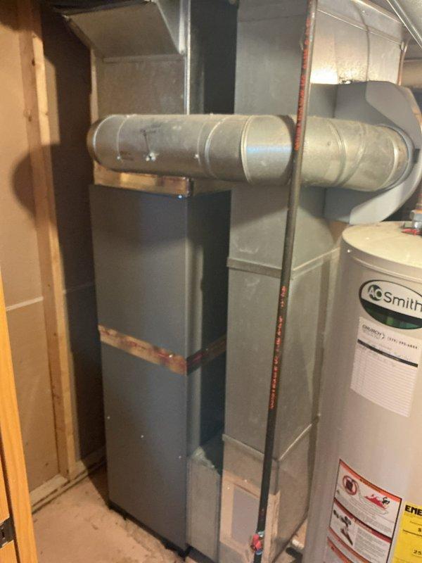 Completed full HVAC system installation in basement utility area including EL297UH070 furnace, ML17KC2-036 air conditioner, CK40CT-36B evaporator coil, and 600 series whole-home humidifier. Reused existing thermostat and filter cabinet to maintain system compatibility. Connected all ductwork, refrigerant lines, and electrical components, then performed system startup with manifold gauge readings confirming proper refrigerant pressures and system operation. Collected outstanding balance upon completion.