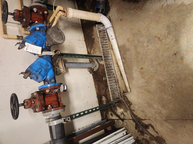 Responded to clogged drain issue and investigated grease line system in mechanical room. Upon inspection, identified potential venting issue affecting drainage performance. Documented existing plumbing configuration including backflow prevention assemblies, PVC drainage piping, and grease line components with photographic evidence showing utility room layout and plumbing installations. Unable to fully resolve issue during initial visit; follow-up appointment scheduled for additional diagnostic evaluation and corrective action.