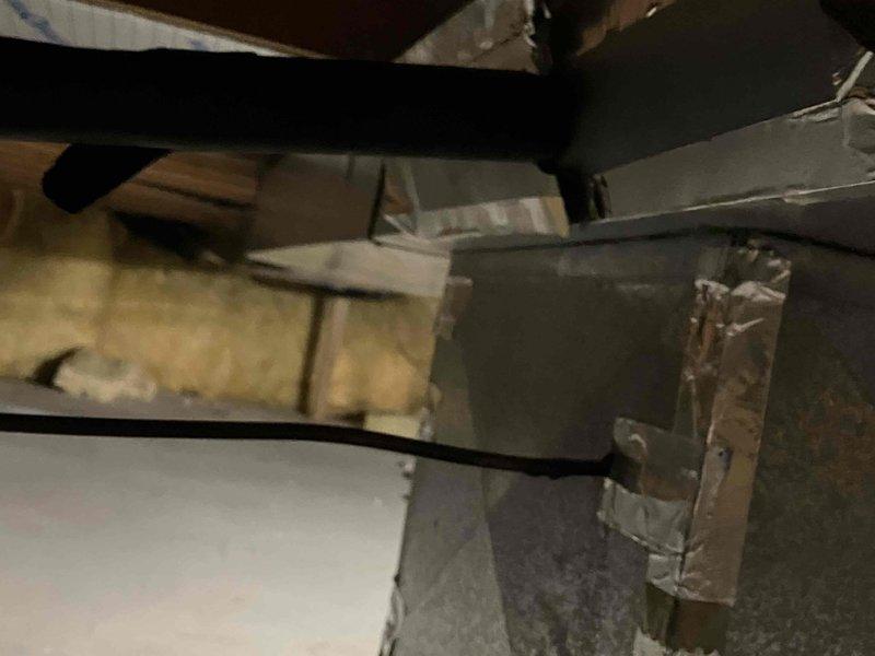 Responded to service call for HVAC system evaluation on residential unit over 20 years old utilizing R22 refrigerant that was found frozen up and inoperable. Conducted comprehensive assessment of existing air conditioning system including inspection of evaporator coil assembly located in attic space and associated ductwork infrastructure. Documentation revealed significant age-related deterioration including visible corrosion and oxidation on copper refrigerant lines, compromised heat exchanger components, and accumulated debris within finned coil sections. System assessment confirmed unit has exceeded serviceable lifespan and utilizes obsolete R22 refrigerant that is no longer readily available or cost-effective for repairs. Captured photographic documentation of existing equipment condition showing deteriorated evaporator coil with rust formation, aging ductwork connections, and overall system infrastructure. Prepared detailed replacement estimate for complete HVAC system upgrade to 