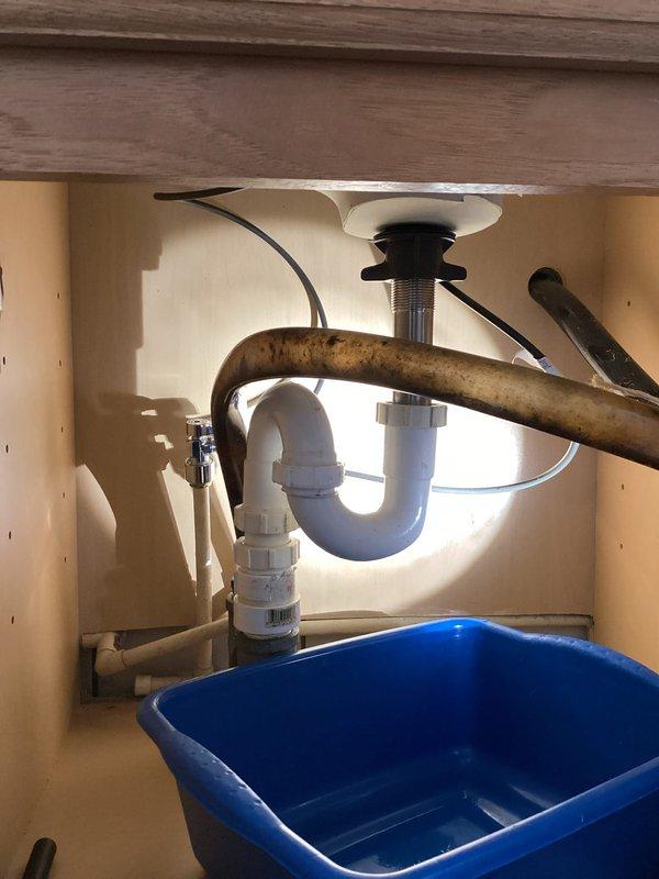 Completed installation of Delta kitchen faucet assembly including mounting hardware, supply line connections, and drain components. Removed existing faucet and associated plumbing, installed new chrome-finished faucet with dual shut-off valves featuring decorative handles, connected hot and cold water supply lines using flexible braided hoses with compression fittings, and verified proper P-trap alignment with existing white PVC drainage system. Tested all connections for leaks, confirmed adequate water pressure and flow at both hot and cold settings, and ensured proper operation of faucet handles and pop-up drain assembly.