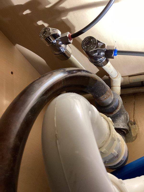 Completed installation of Delta kitchen faucet assembly including mounting hardware, supply line connections, and drain components. Removed existing faucet and associated plumbing, installed new chrome-finished faucet with dual shut-off valves featuring decorative handles, connected hot and cold water supply lines using flexible braided hoses with compression fittings, and verified proper P-trap alignment with existing white PVC drainage system. Tested all connections for leaks, confirmed adequate water pressure and flow at both hot and cold settings, and ensured proper operation of faucet handles and pop-up drain assembly.