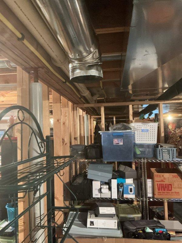 Completed punch list items from previous A/C installation by connecting low voltage wiring to humidifier using spade connectors for 18 AWG wire and installing 8" return duct in basement, relocating intake point to over 10 feet from water heater to meet code compliance requirements. All ductwork properly secured with metal strapping and system tested for proper airflow.
