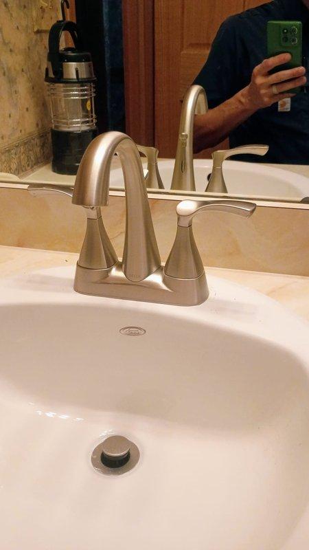Installed customer-supplied brushed nickel bathroom faucet with matching handles on existing vanity sink per quoted specifications. Verified proper water flow, tested drain assembly operation, and confirmed no leaks at supply line connections upon completion.