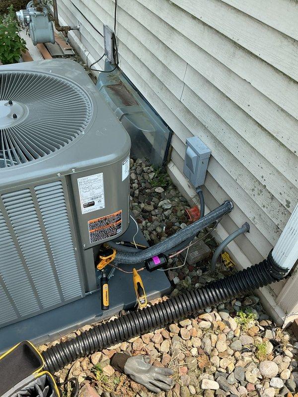 Completed full A/C system installation including ML13KC1-030 outdoor condenser unit and CK40CT-30B indoor coil. Vacuumed and thoroughly cleaned blower cabinet and blower wheel to ensure optimal airflow. Adjusted blower speed settings to accommodate upgraded 2.5 ton air conditioning capacity, replacing existing 2 ton system. Installed thermostat utilizing existing T4/T6 stats. All electrical connections, refrigerant lines, and condensate drainage properly installed and secured. System tested and verified operational. Equipment models and serial numbers documented in service records.