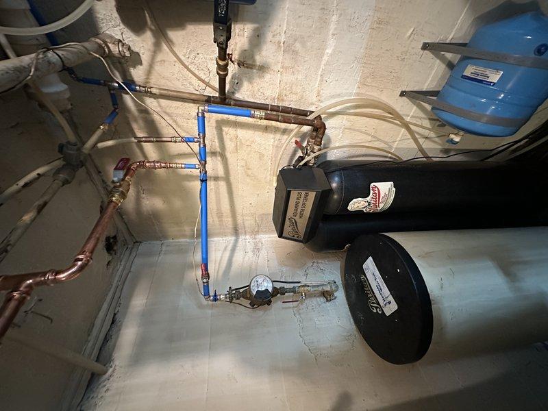 Replaced deteriorated section of galvanized water line with copper piping and installed four new shut-off valves to improve water flow and prevent future corrosion issues. Work was completed in the mechanical room where existing plumbing infrastructure, water treatment system, and pressure tank are located.