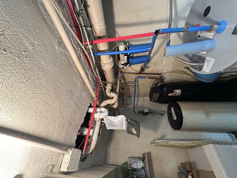 Replaced deteriorated section of galvanized water line with copper piping and installed four new shut-off valves to improve water flow and prevent future corrosion issues. Work was completed in the mechanical room where existing plumbing infrastructure, water treatment system, and pressure tank are located.