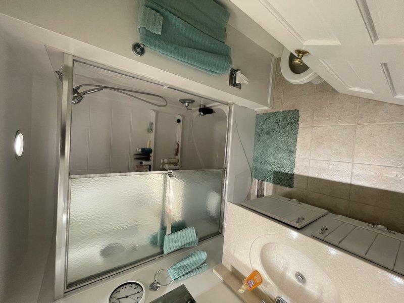 Responded to service call for reported water leak from upstairs toilet running down exterior plumbing lines into basement. Upon arrival, water supply was already shut off by homeowner with no standing water present. Conducted thorough inspection of upstairs bathroom toilet and surrounding plumbing fixtures. Examined toilet base, supply line connections, flush valve assembly, and wax ring seal for signs of active leakage or water damage. Documented bathroom conditions with photographic evidence showing clean, well-maintained fixtures and no visible water staining on flooring or walls at time of inspection.