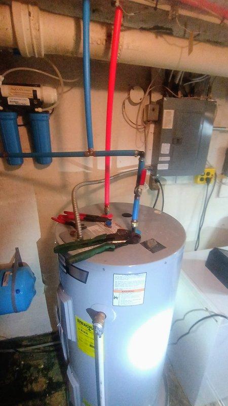 Responded to service call regarding reported water softener leak following previous day's service work. Conducted thorough inspection of utility room plumbing systems including water heater, water softener, filtration system, pressure tank, and associated PEX and copper piping. Examined all connections, fittings, and recently serviced components for signs of active leaking or moisture. Inspected water softener unit, inlet/outlet connections, drain line, and brine tank for potential leak sources. Verified proper operation of expansion tank, pressure vessel, and water treatment equipment. Documented existing plumbing configuration and equipment conditions with photographs for service records.