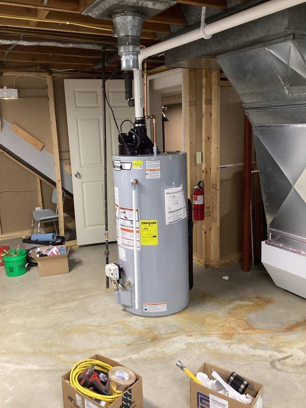 Replaced existing 40-gallon draft vented water heater with a new 40-gallon power vent unit in basement utility area. Installed first-time PVC venting system to accommodate the power vent configuration. Added a new electrical outlet at ceiling level, connected to an available breaker in the electrical panel to provide power for the water heater's vent blower. Installed a Honeywell automatic shut-off valve on the main water supply line for enhanced safety and leak protection. All plumbing connections, gas lines, and venting were completed per manufacturer specifications and local code requirements. System was tested and verified operational upon completion.