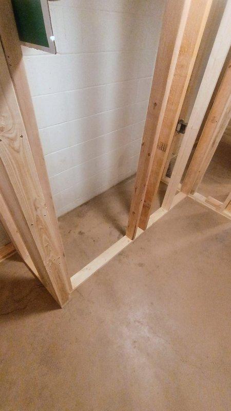 Provided plumbing estimate for installation of new backup sump pump system in unfinished basement area. Assessed site conditions including existing rough-in requirements for drainage piping, evaluated wooden framed utility space with exposed joists and concrete flooring, and documented installation location for backup pump configuration to supplement primary system.
