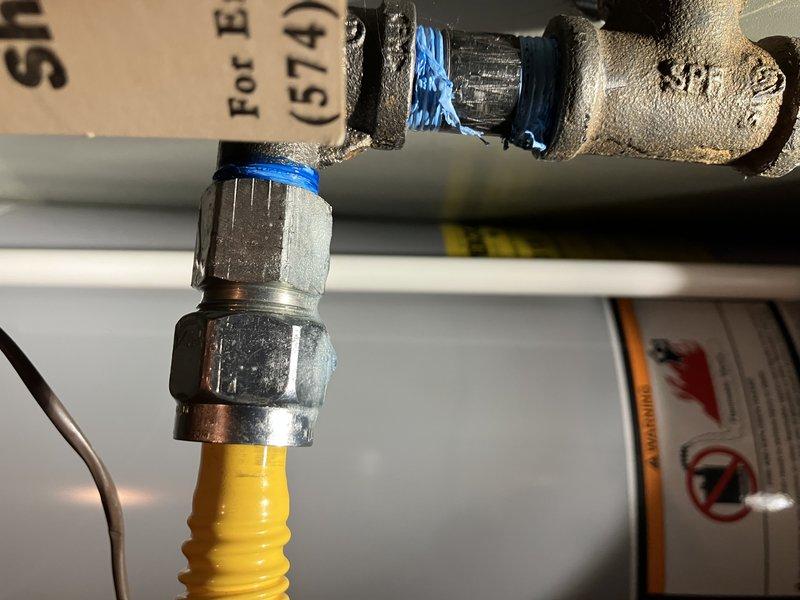 Responded to reported gas leak at furnace connection point. Upon arrival, gas was already shut off at the meter and leak location had been marked by gas company. Performed inspection of flexible gas line connection to furnace, identifying leak at brass fitting connection point. Tightened compression fitting on yellow corrugated flexible gas connector using appropriate wrench while wearing proper safety equipment. Applied thread sealant to ensure proper seal at connection points. Conducted pressure test on gas line to verify leak was resolved and system integrity was restored. All connections tested and confirmed leak-free before restoring gas service.