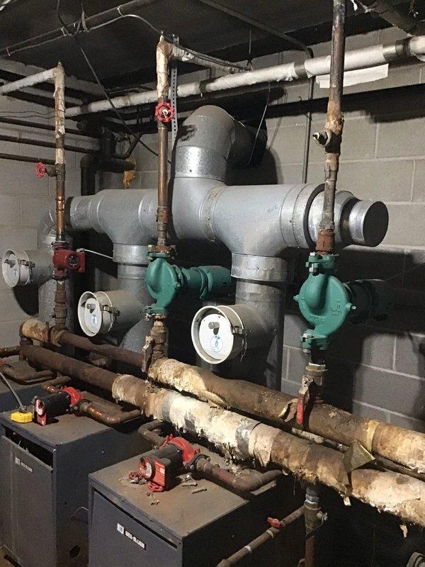 # HVAC Maintenance - Planned Single Maintenance

Completed first visit air conditioning maintenance as part of new enrollment service agreement. Performed comprehensive system inspection and documentation of existing mechanical equipment including dual boiler heating system with associated piping network, circulator pumps, expansion tanks, and pressure controls. Observed significant corrosion on horizontal pipe runs and oxidation on copper piping throughout mechanical room, which was photographed for record and future reference.
