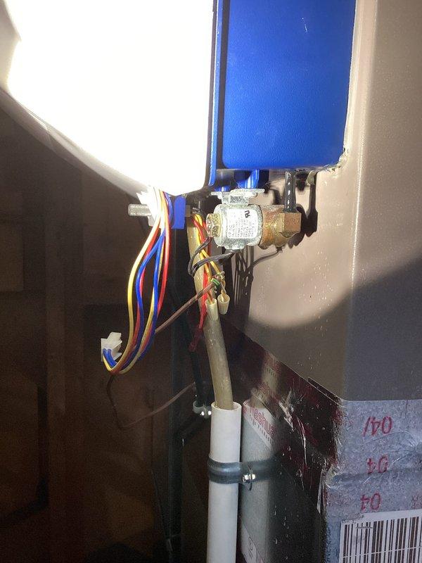 Responded to water leak in basement originating from copper piping above furnace humidifier. Inspected plumbing infrastructure in ceiling joists and identified leak at T-joint fitting in copper supply line. Assessed humidifier installation and associated water feed connections, including solenoid valve and brass fittings with integrated electrical controls. Advised customer of diagnostic findings and service fee for evaluation.