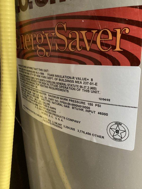 Responded to service call for 6.5-year-old energySaver tanked water heater with no hot water production and confirmed unit was non-operational. Performed diagnostic inspection of the gas-fired water heater, model NOPH-50-M00N010000 with 46,000 BTU/HR input capacity, and documented equipment specifications including 150 PSI maximum working pressure and foam insulation R-value. Assessed unit condition, verified no water leakage present, and photographed equipment nameplate and installation for service records.