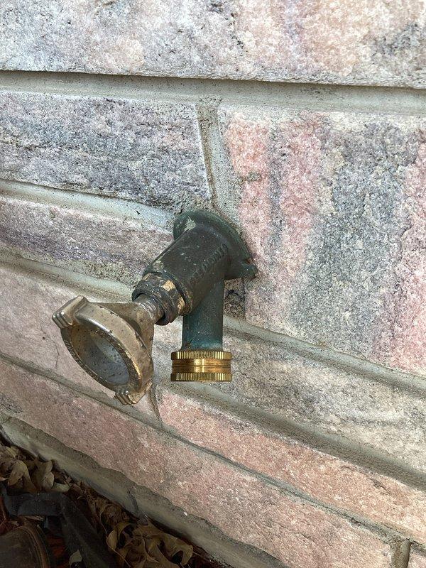 Responded to customer report of sill faucet that would not shut off. Upon inspection, identified exterior hose bib with worn internal components preventing complete water shutoff. Documented existing plumbing configuration including interior shutoff valve with blue handle and brass elbow fittings mounted to ceiling structure. Photographed outdoor spigot installation showing aged fixture with corrosion on body and handle mechanism. Provided customer with counter sale parts and technical guidance for repair, including replacement washer, stem assembly, and installation instructions for restoring proper shutoff function to the exterior faucet.