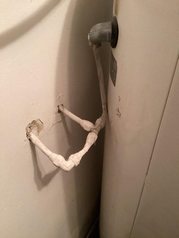 Provided estimate for electric water heater replacement in residential property. Assessed existing plumbing configuration including corroded water supply lines, aged shutoff valves, and drainage system with visible deterioration on surrounding wall surfaces. Service fee waived for this quotation visit.