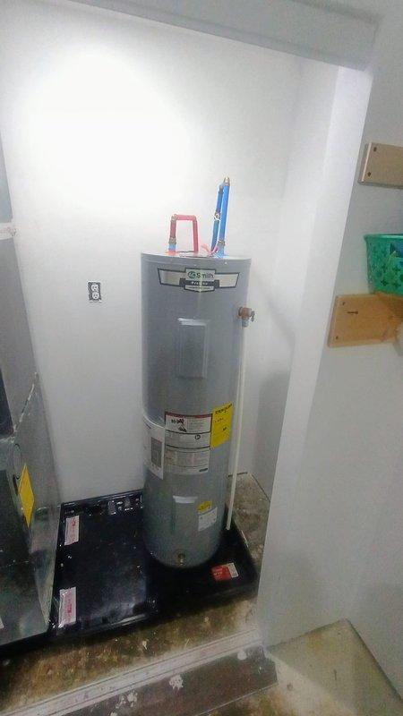 Installed 40-gallon electric water heater in basement utility alcove and reinstalled water softener system with proper connections. Completed plumbing connections between water heater, softener tank, and blue pressure tank, ensuring all components were properly integrated into the existing system. Provided quote for potential re-piping configuration to route all water through softener except exterior sill faucets.