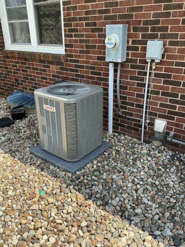 Completed installation of new Lennox ML13KC1-024 air conditioning condenser unit and CK40CT-24-71 evaporator coil at residential property. Unit was properly mounted on composite pad with river rock base, all electrical connections completed including disconnect box and conduit installation, system tested and verified operational.