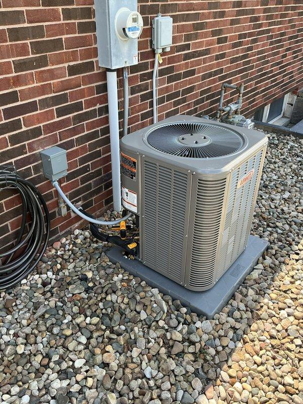 Completed installation of new Lennox ML13KC1-024 air conditioning condenser unit and CK40CT-24-71 evaporator coil at residential property. Unit was properly mounted on composite pad with river rock base, all electrical connections completed including disconnect box and conduit installation, system tested and verified operational.