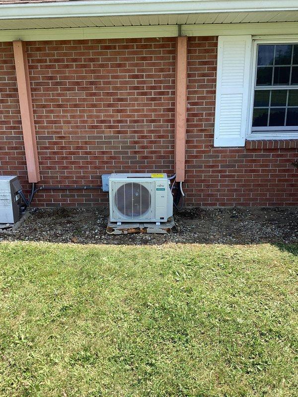Installed a new Fujitsu ductless mini-split system in room 109, including indoor wall-mounted air handler positioned near ceiling and outdoor condensing unit on concrete pad against brick exterior. System fully operational with electrical connections, refrigerant lines, and condensate drain properly installed per manufacturer specifications.