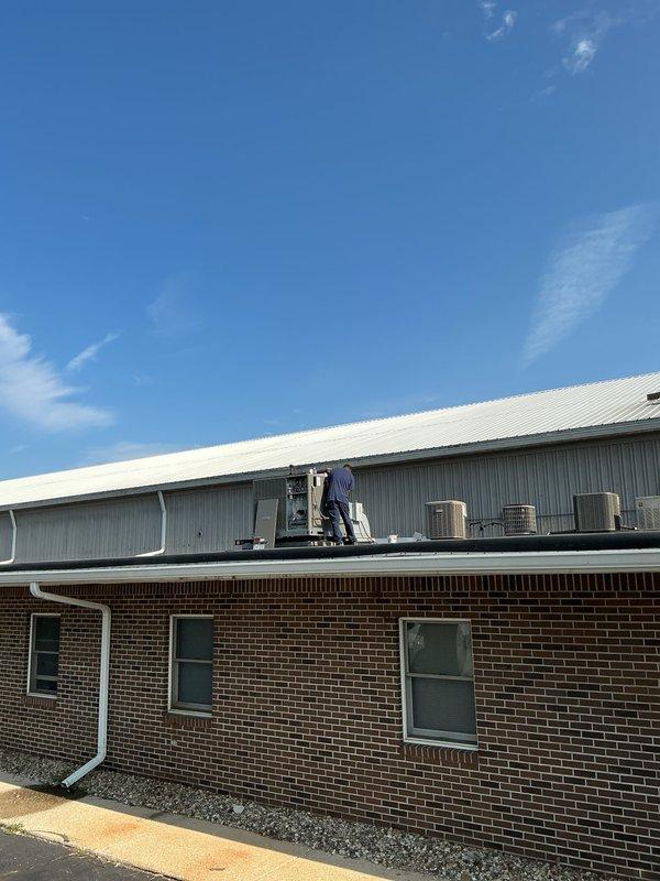 Completed rooftop installation of Lennox package unit with integrated filter rack accommodating two 20x20x1 filters. Fabricated and installed custom supply and return air transitions with internal duct liner for improved thermal performance and noise reduction. Overlaid deteriorated sheet metal cap to restore structural integrity and weather protection. Applied mastic sealant coating to all exposed ductwork to ensure proper air sealing and system efficiency.