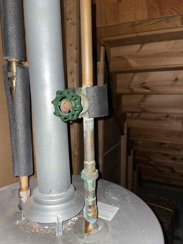 Responded to service call for a 9-year-old tanked water heater reported as non-operational with active leaking. Upon arrival, conducted visual inspection of the unit and surrounding area, documenting conditions with photographs. Confirmed presence of water pooling at the base of the water heater on the concrete floor, indicating significant leak compromising system integrity. Examined upper connections including shut-off valve, supply lines, and copper piping, noting visible corrosion and blue-green patina on aged copper connections. Assessed the overall condition of the unit, including insulated piping, metallic connections, and manufacturer labeling. Due to the age of the equipment, extent of the leak, and compromised operational status, determined that the water heater was beyond economical repair and recommended full unit replacement to restore hot water service and prevent further water damage to the utility area.