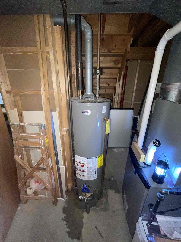 Responded to service call for a 9-year-old tanked water heater reported as non-operational with active leaking. Upon arrival, conducted visual inspection of the unit and surrounding area, documenting conditions with photographs. Confirmed presence of water pooling at the base of the water heater on the concrete floor, indicating significant leak compromising system integrity. Examined upper connections including shut-off valve, supply lines, and copper piping, noting visible corrosion and blue-green patina on aged copper connections. Assessed the overall condition of the unit, including insulated piping, metallic connections, and manufacturer labeling. Due to the age of the equipment, extent of the leak, and compromised operational status, determined that the water heater was beyond economical repair and recommended full unit replacement to restore hot water service and prevent further water damage to the utility area.