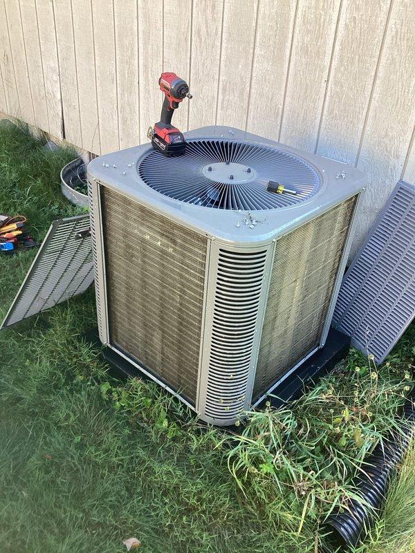 Completed scheduled cooling maintenance on residential outdoor condensing unit. Performed comprehensive system inspection, removed and cleaned exterior panels showing weather-related dirt and grime buildup, verified proper drainage line function, and tested all mechanical components for optimal performance during cooling season.