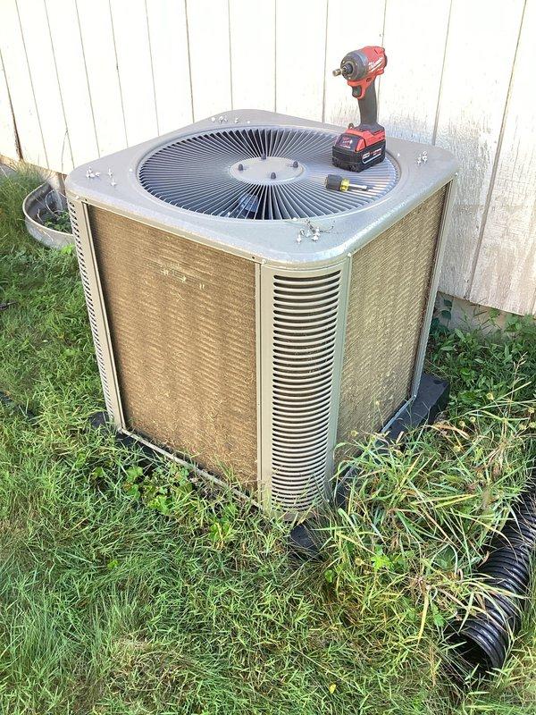 Completed scheduled cooling maintenance on residential outdoor condensing unit. Performed comprehensive system inspection, removed and cleaned exterior panels showing weather-related dirt and grime buildup, verified proper drainage line function, and tested all mechanical components for optimal performance during cooling season.