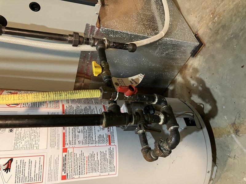 Successfully installed a 40-gallon atmospheric draft water heater in office utility room per customer quote. Completed all plumbing connections including hot and cold water supply lines with proper shut-off valves, pressure relief valve installation, and draft hood assembly. Unit was positioned, leveled, and secured in designated location with all copper piping, brass fittings, and flexible connectors properly installed and tested for leaks. System was filled, fired, and verified for proper operation with no issues detected.