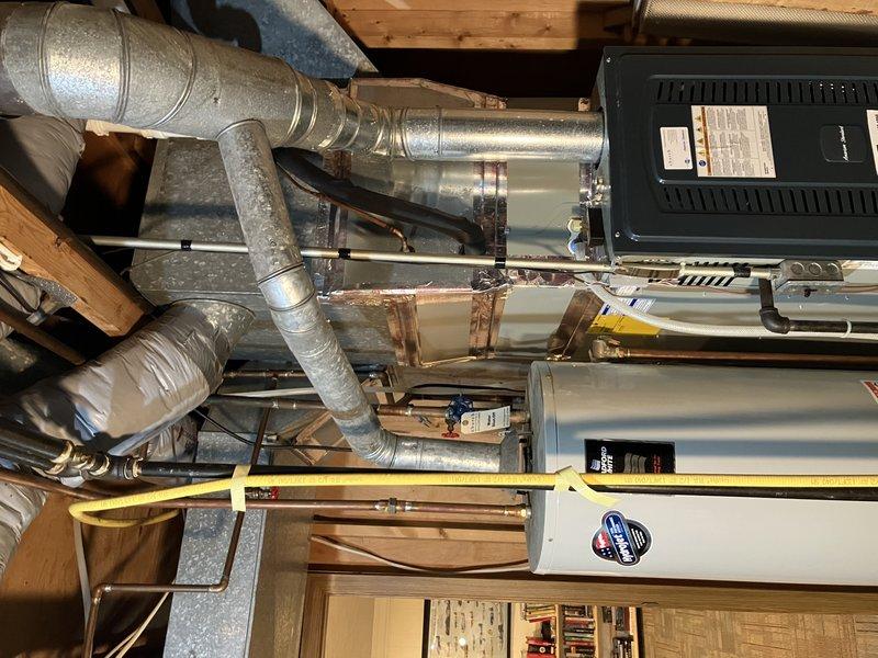 Successfully installed a 40-gallon atmospheric draft water heater in office utility room per customer quote. Completed all plumbing connections including hot and cold water supply lines with proper shut-off valves, pressure relief valve installation, and draft hood assembly. Unit was positioned, leveled, and secured in designated location with all copper piping, brass fittings, and flexible connectors properly installed and tested for leaks. System was filled, fired, and verified for proper operation with no issues detected.
