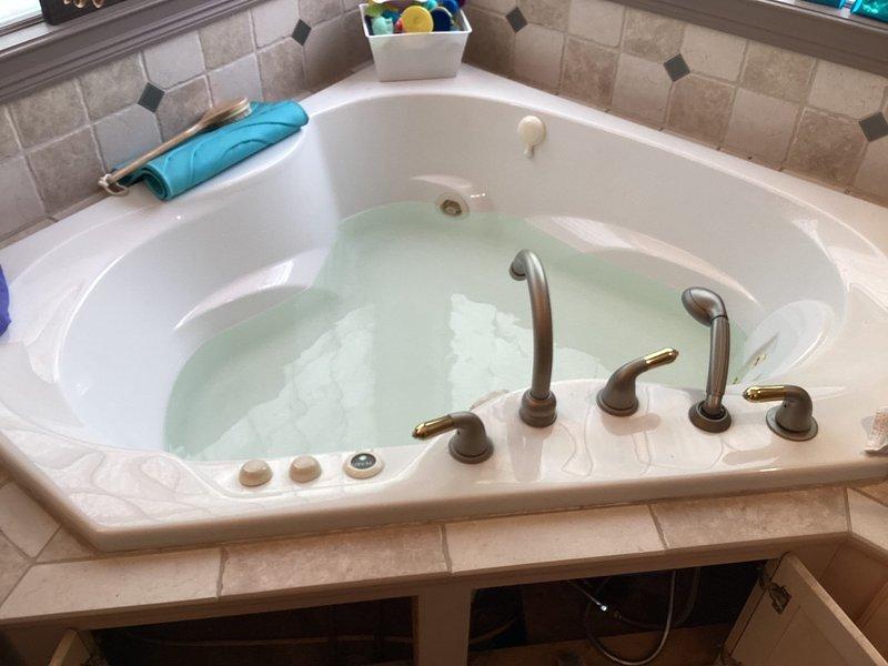 Responded to water leak in basement bathroom. Upon inspection, identified active leak originating from water heater supply line connections. Found deteriorated flexible connector with visible water damage to surrounding flooring and carpet. Shut off water supply to affected fixture, replaced failed braided stainless steel supply line, and tested all connections for proper seal. Verified no additional leaks present and restored water service to unit.
